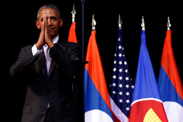 US President Barack Obama holds his hands together and bows at the end of his address at the Lao National Cultural Hall, on the sidelines of the ASEAN Summit, in Vientiane, Laos, on Tuesday (Reuters photo)